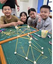 Students worked in teams to build tall towers with marshmallows and spaghetti, practicing creativity, teamwork, and problem-solving.
